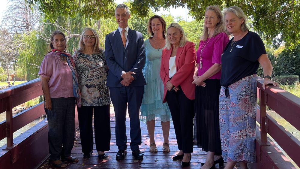 A group of dignatories gathered in a garden to announce the launch of the Armadale FDV hub